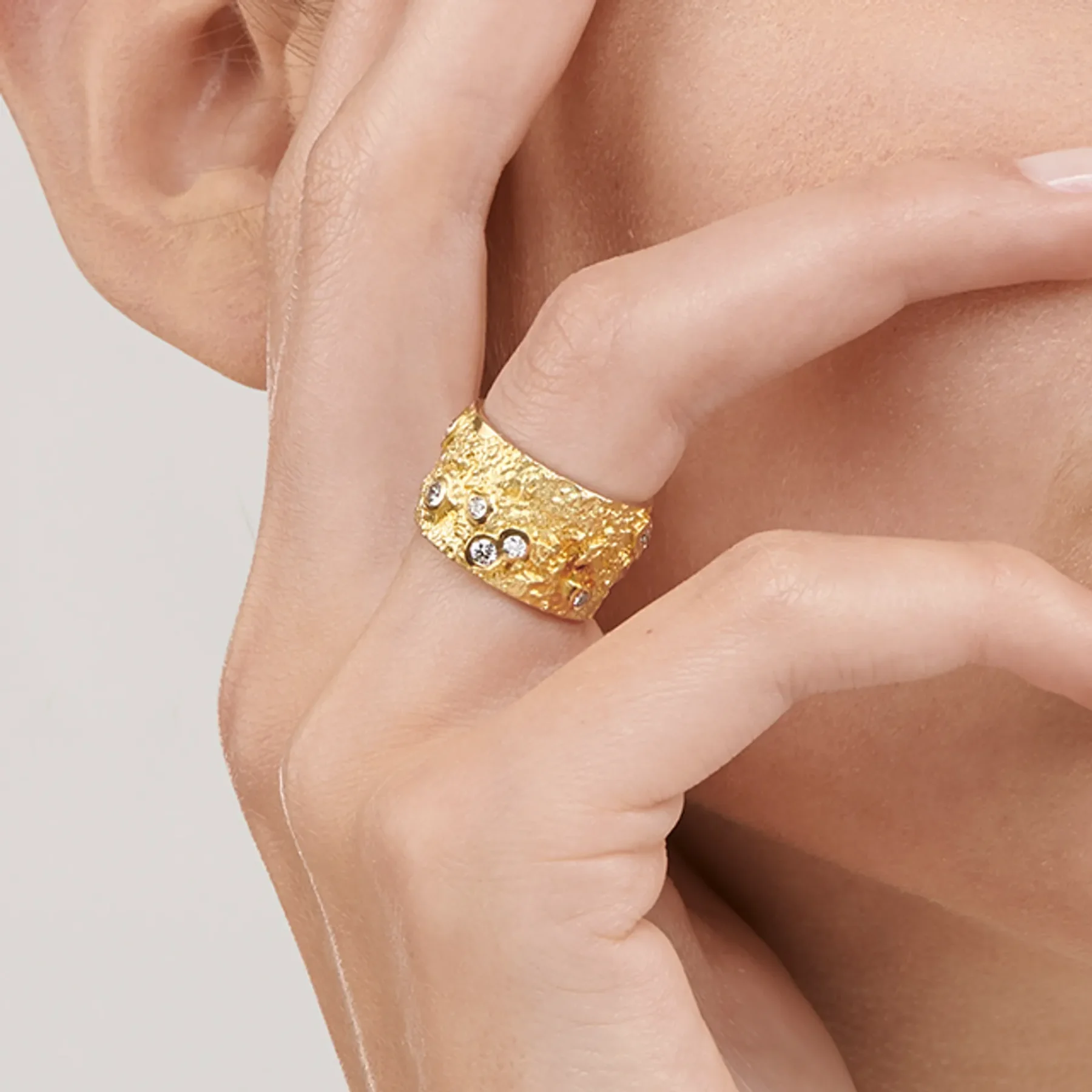 Close up image of the Ténéré Alliance Yellow Gold Ring with Diamonds designed by Thierry Vendôme worn by @celinemarechal