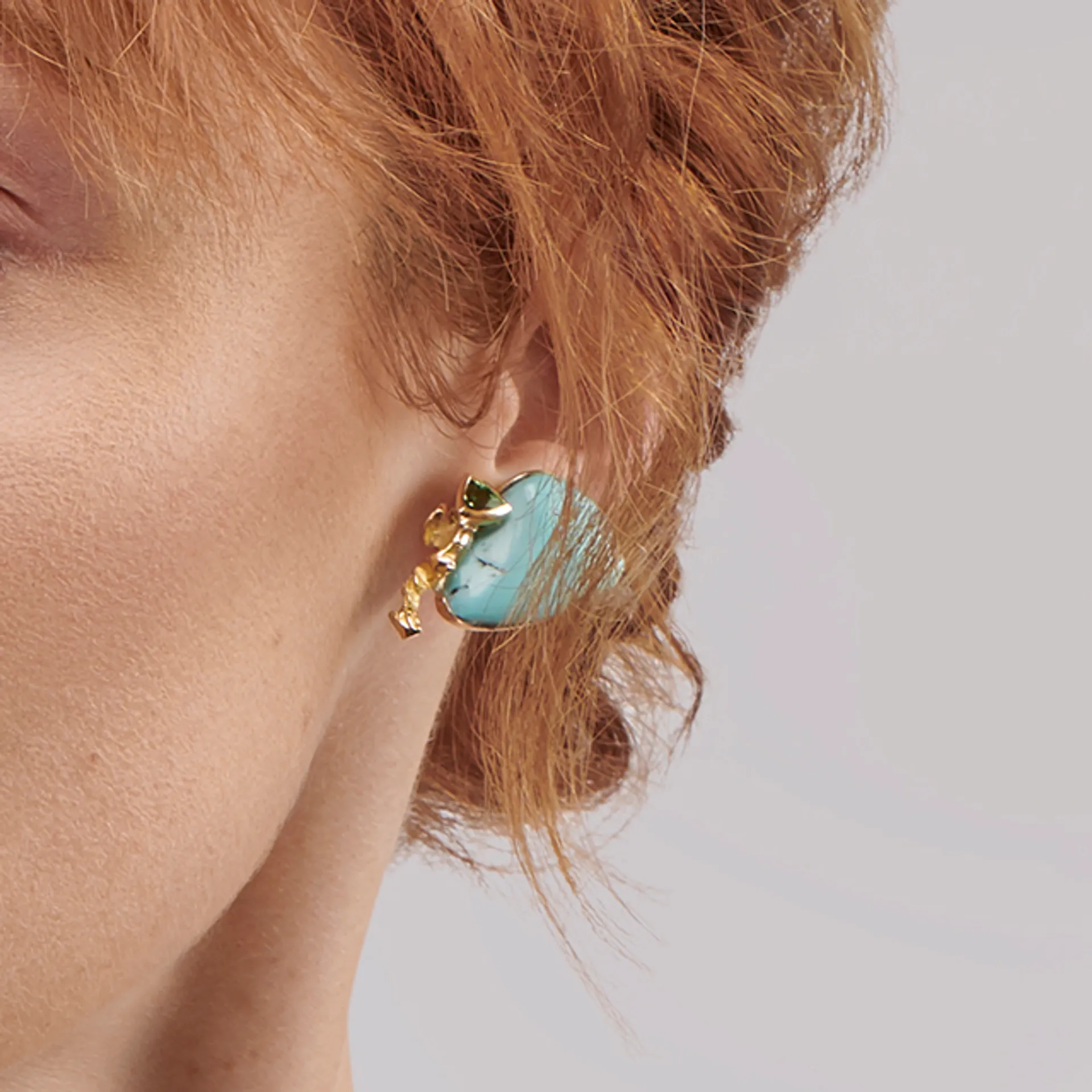 Close up image of the Turquoise Branch Yellow Gold Earrings with Green Tourmaline designed by Thierry Vendôme worn by @lucy.m.w